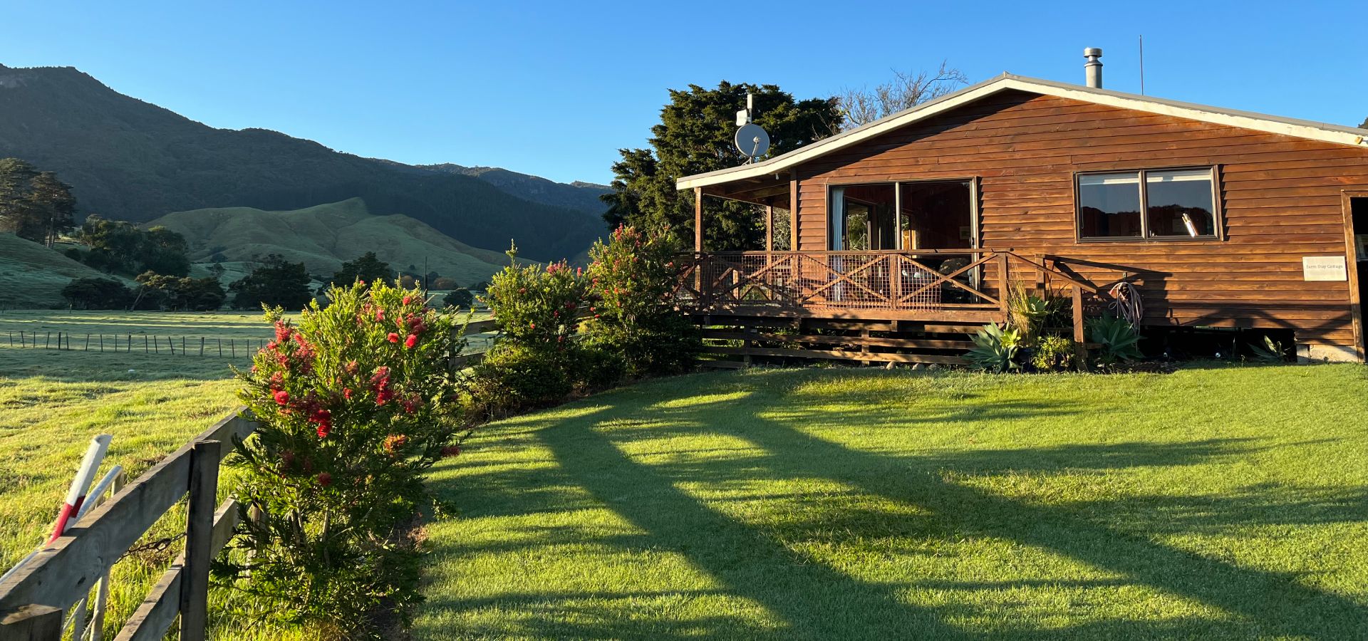 Charming farm stay cottage at Whitestar Station surrounded by rolling green hills and Hereford cattle, offering authentic rural accommodation in Colville, Coromandel.