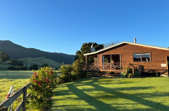 The 2-bedroom Farm Stay cottage at Whitestar Station in Colville, showing the timber exterior and scenic rural farm setting