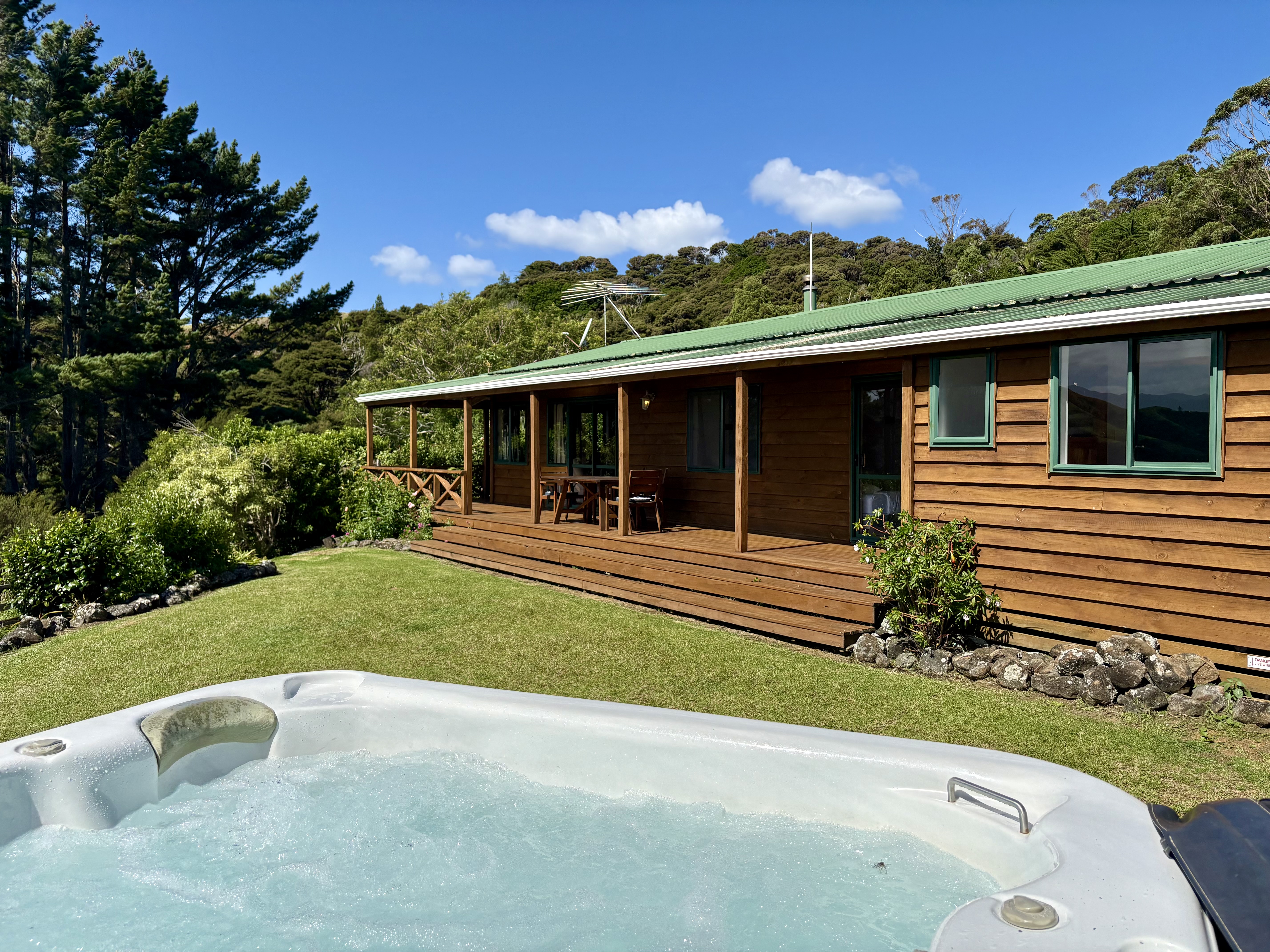 Luxury farm stay accommodation with outdoor spa pool and ocean views at Whitestar Station, Colville. Perfect romantic getaway in Northern Coromandel.