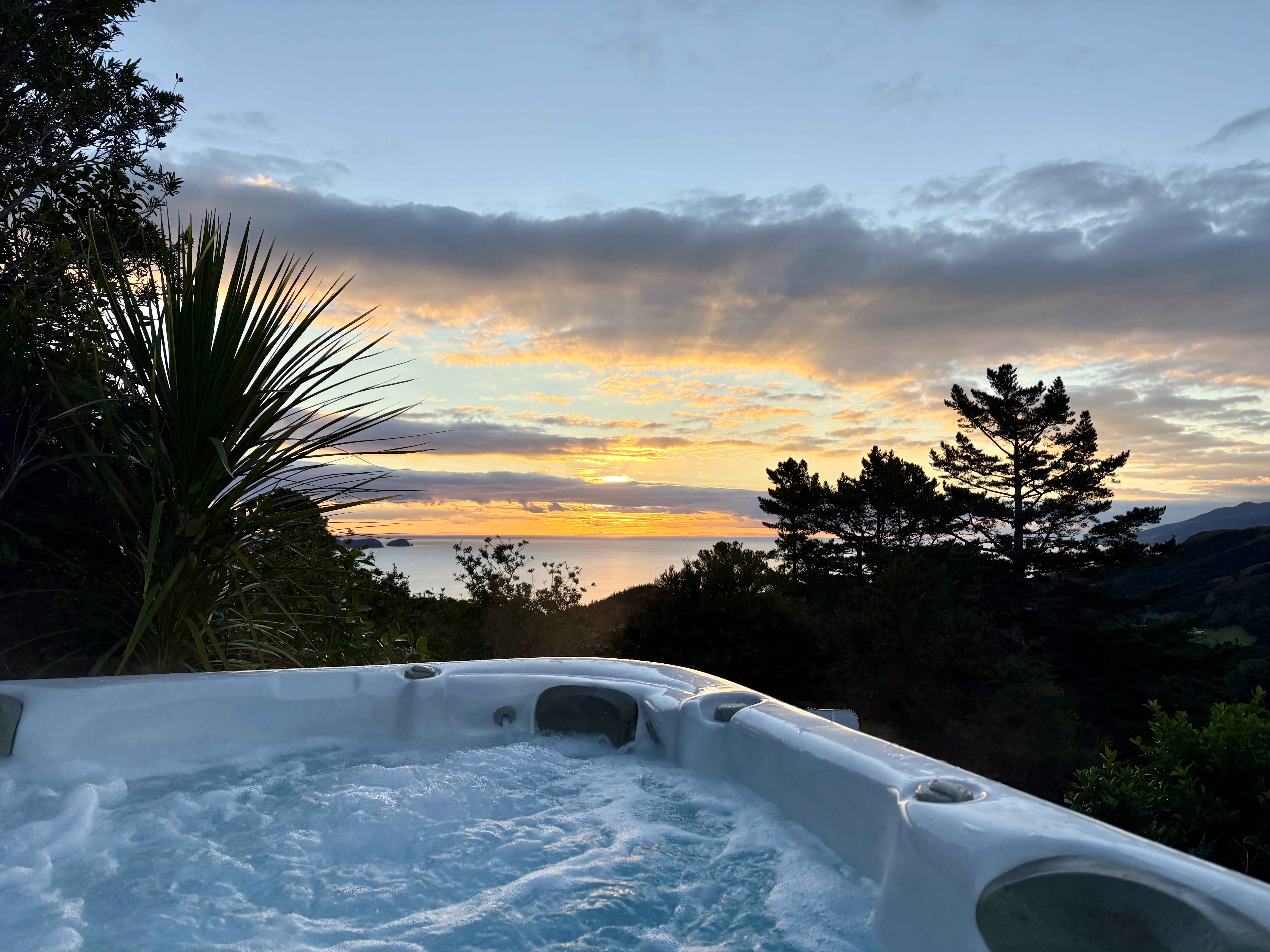 Luxury farm stay accommodation with outdoor spa pool and ocean views at Whitestar Station, Colville. Perfect romantic getaway in Northern Coromandel.
